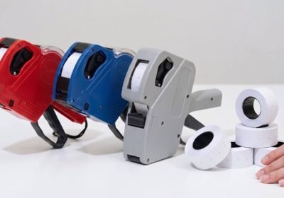 Red and blue Easy Tag price guns beside a plain grey competitor gun