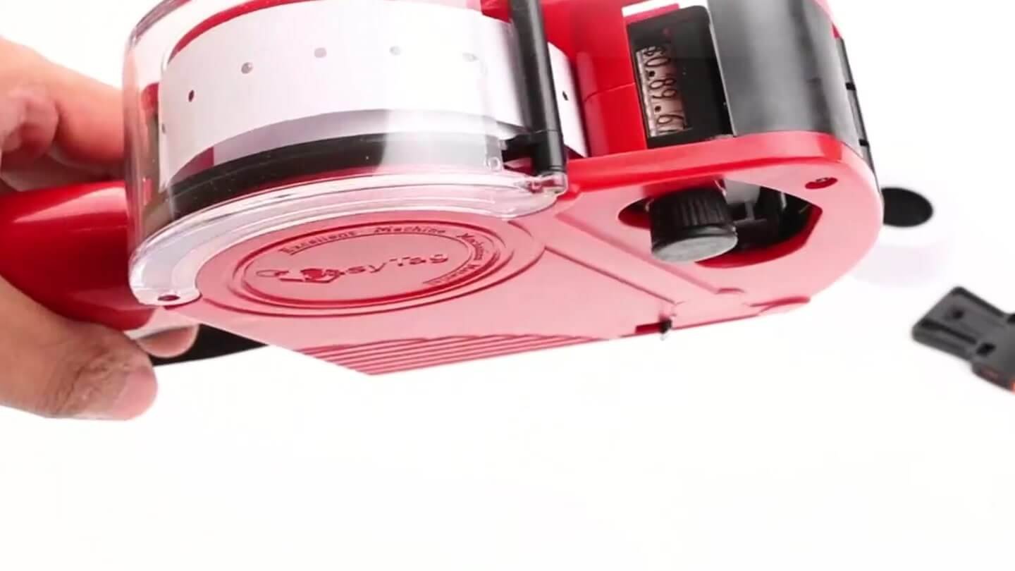 Loading a fresh label roll into an MX5500 price gun
