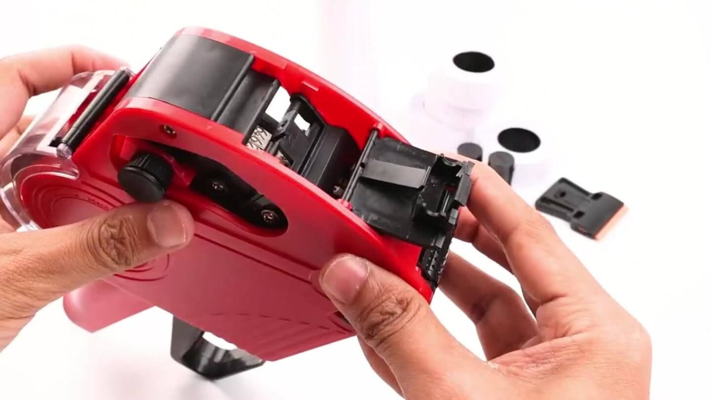 Fitting a fresh ink roller into a red MX5500 price gun